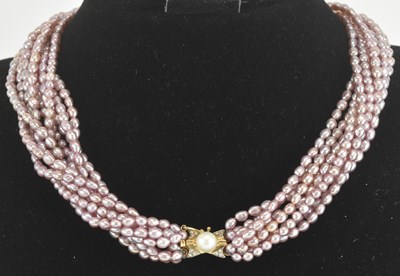 Lot 1392 - A multi-strand pink pearl necklace, with...