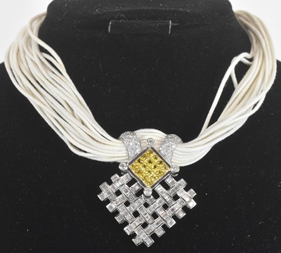 Lot 1375 - An 18ct white gold diamond and yellow sapphire...