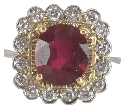 Lot 1213 - A white metal ruby and diamond cluster ring,...