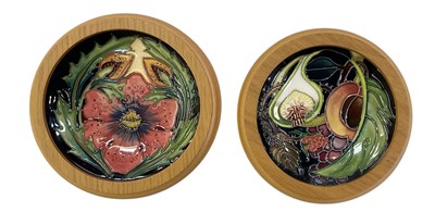 Lot 666 - MOORCROFT; two blue ground floral decorated...