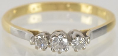 Lot 1299 - An 18ct gold ring, set with three small claw...