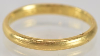 Lot 1301 - A 22ct gold thin band ring, rubbed marks, size...