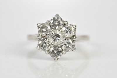 Lot 47 - An 18ct white gold diamond seven stone daisy...