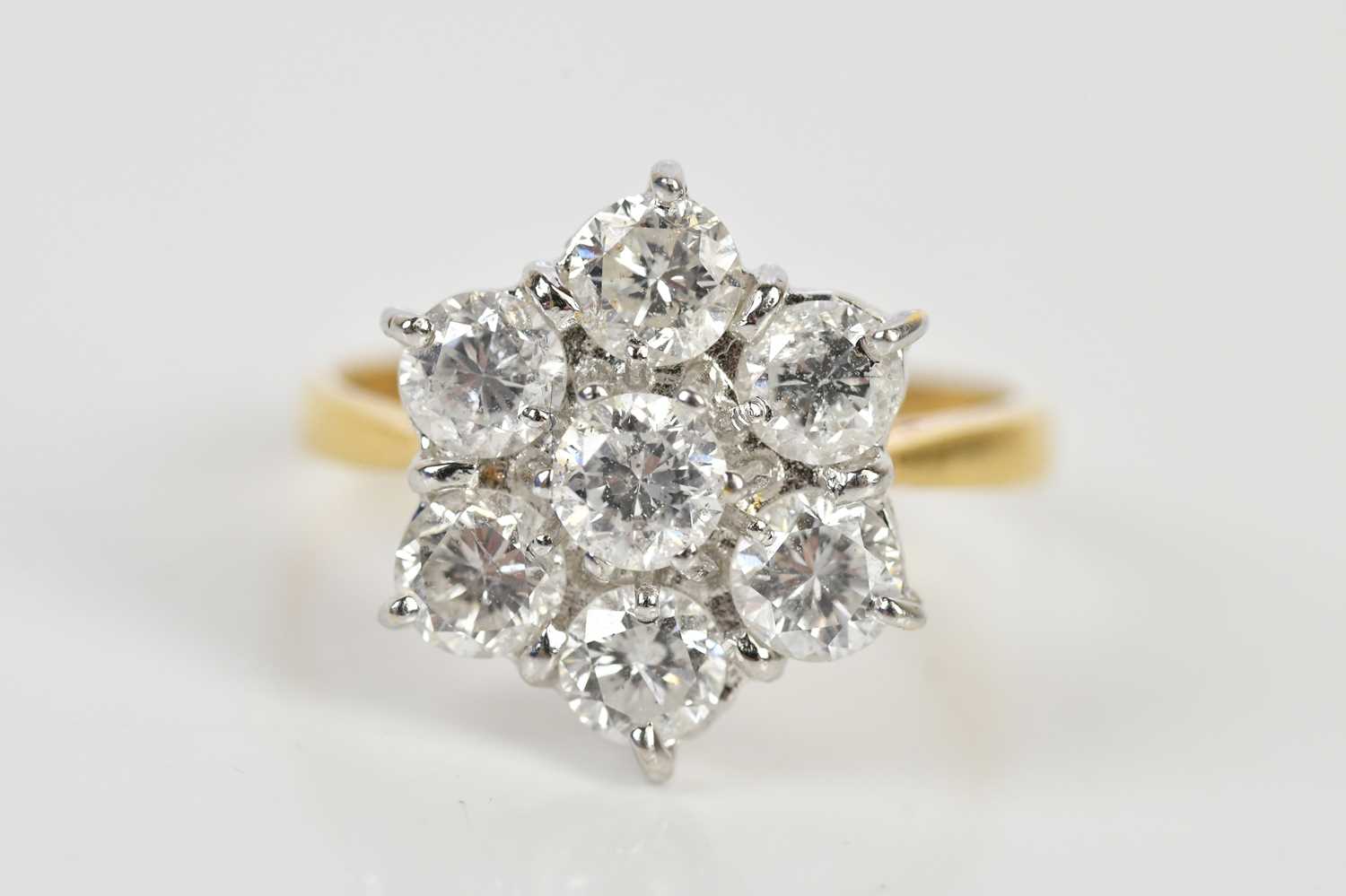Lot 38 - An 18ct yellow gold diamond seven stone daisy...