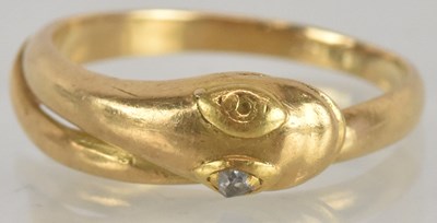 Lot 1312 - A gold snake head ring with diamond set eyes,...