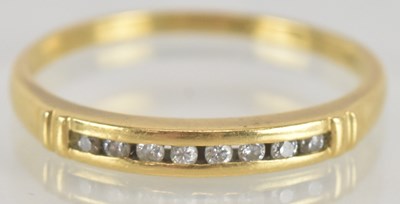 Lot 1332 - A gold ring with eight small channel set...