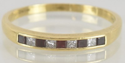 Lot 1239 - An 18ct gold diamond and ruby ring, the four...