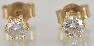 Lot 1491 - A pair of gold diamond stud earrings, each set...
