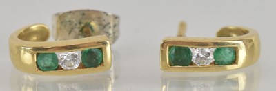 Lot 1500 - A pair of diamond and emerald set small stud...