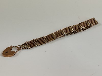 Lot 537 - A 9t rose gold four bar gate link bracelet,...