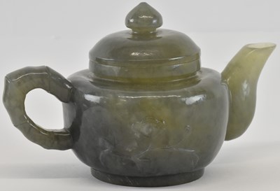 Lot 1033 - An early 20th century Chinese carved jade...