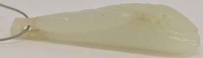 Lot 586 - A Chinese carved jade pendant, decorated with...