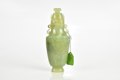 Lot 73 - A Chinese jade twin handled vase and cover,...