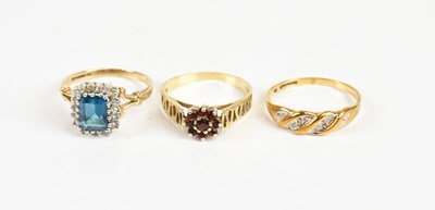Lot 1612 - Three 9ct gold dress rings, including a daisy...