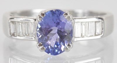 Lot 1160 - An 18ct white gold tanzanite and diamond ring,...