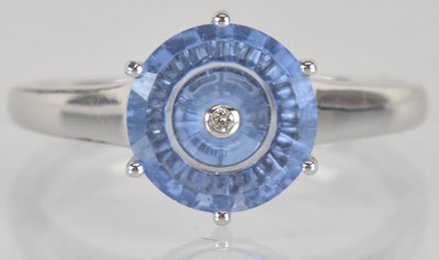 Lot 1276 - A white metal blue topaz and diamond ring,...