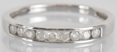 Lot 1286 - A 9ct white gold diamond set half eternity...