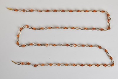 Lot 1390 - A yellow metal long link amber set necklace,...