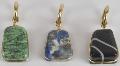 Lot 1252 - Three yellow metal mounted hardstone pendants,...