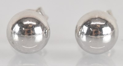 Lot 1514 - A pair of 18ct white gold ear studs, combined...