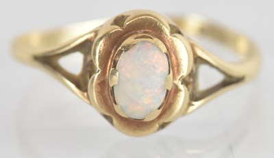 Lot 1366 - A 9ct yellow gold opal set ring, the central...