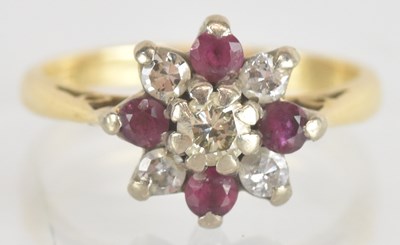 Lot 1240 - An 18ct ruby and diamond flower head cluster...