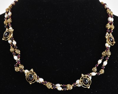 Lot 1427 - A yellow metal cabochon garnet and seed pearl...