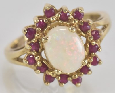 Lot 1323 - A 9ct gold opal and ruby cluster set dress...