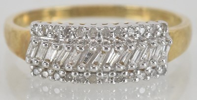 Lot 1361 - A 9ct gold dress ring, with a central line of...