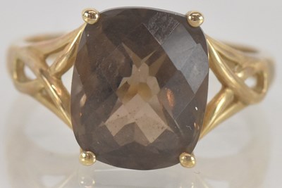 Lot 1362 - A modern 9ct gold dress ring, with cut smoky...