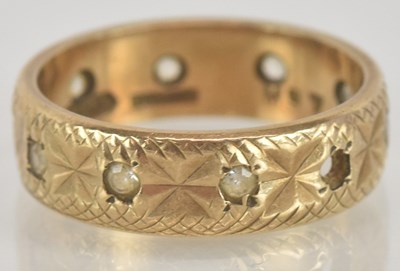 Lot 1320 - A 9ct gold band ring, with a central band of...