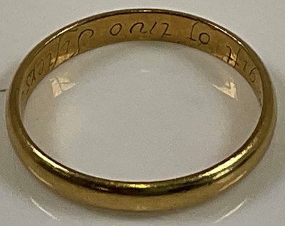 Lot 532 - An unusual early yellow metal wedding band,...
