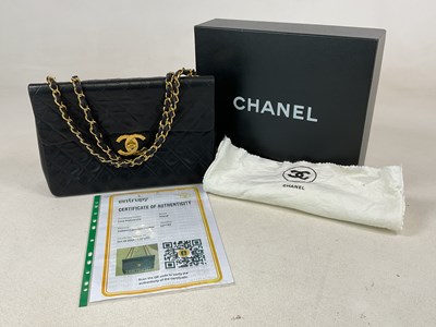 Lot 153 - CHANEL; a jumbo quilted black lambskin leather...