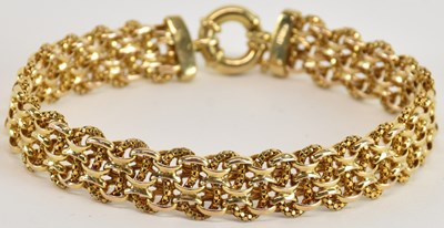 Lot 1596 - A 9ct gold multi-ring link bracelet, with...