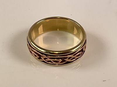 Lot 564 - CLOGAU; a 9ct gold wedding band with Celtic...