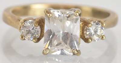 Lot 1309 - A 9ct yellow gold clear glass three stone ring,...
