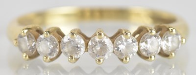 Lot 1197 - A 14ct yellow gold seven white stone ring,...