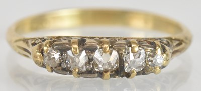 Lot 1265 - An 18ct yellow gold diamond four stone ring,...