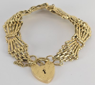 Lot 1587 - A 9ct yellow gold gate link bracelet, with...