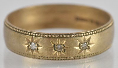 Lot 1330 - A 9ct yellow gold diamond three stone wedding...