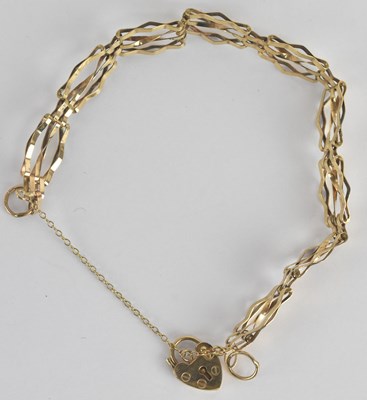 Lot 1614 - A 9ct yellow gold gate link bracelet, with...