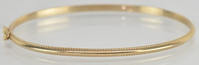 Lot 1623 - A 9ct yellow gold bangle, diameter approx...