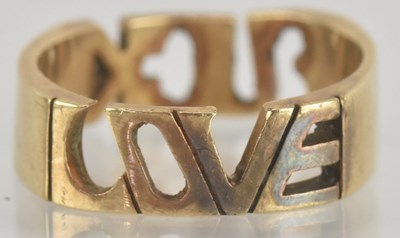 Lot 1288 - A yellow metal band ring, inscribed 'F*ck Love'...