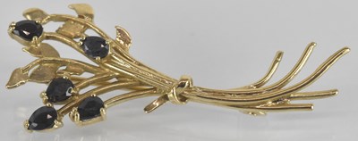 Lot 1560 - A yellow metal sapphire set floral spray...