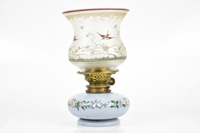 Lot 2410 - A blue glass floral decorated oil lamp, height...