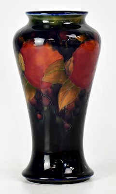 Lot 227 - MOORCROFT; a blue ground 'Pomegranate' vase,...