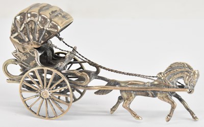 Lot 1081 - A white metal miniature model of a horse drawn...