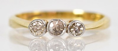 Lot 756 - An 18ct yellow gold ring set with three...