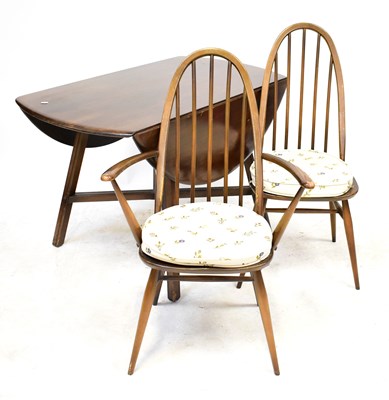 Lot 98 - ERCOL; a dark stained elm drop-leaf dining...
