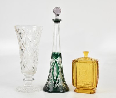 Lot 320 - An Art Deco amber glass jar and cover, relief...